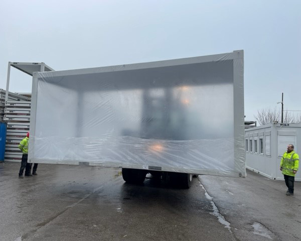 Modular building cover on forklift
